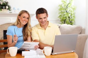 iS_14027868XSmall-smiling-couple-paying-bills.jpg